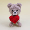 Handmade crochet bear holding a red heart