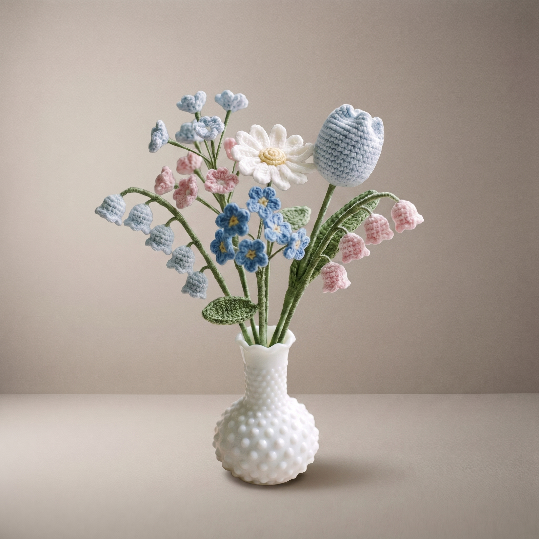 Handmade crochet new baby bouquet of soft blue and pink pastel flowers in a vase